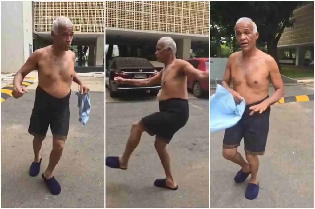 Sargento Isidório sem camisa gesticulando e se movimentando em área externa durante gravação informal em via pública.