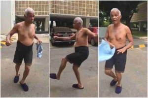 Sargento Isidório sem camisa gesticulando e se movimentando em área externa durante gravação informal em via pública.