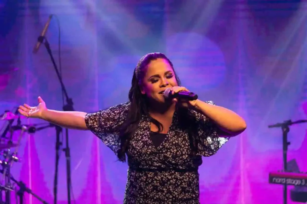 Cantora Cassiane ministrando louvor com emoção durante apresentação ao vivo em evento gospel.