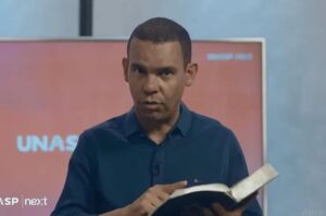 Rodrigo Silva ensinando com Bíblia aberta e expressão séria durante estudo bíblico em estúdio de gravação.