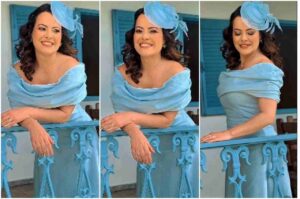 Ana Paula Valadão usando vestido azul claro e chapéu elegante em varanda decorada.