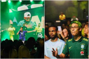 Fiéis acompanham transmissão de jogo da Seleção Brasileira em evento realizado por igreja, com palco iluminado e público usando camisas do Brasil.