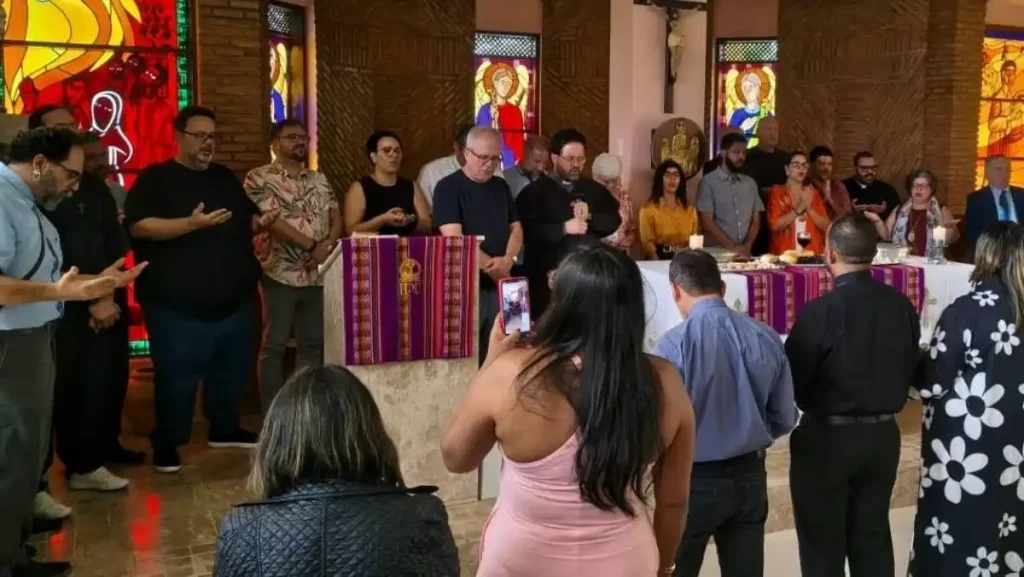 Líderes religiosos e fiéis participam de celebração diante do altar em uma igreja