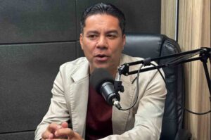 Pastor Leonardo Borges participa de entrevista em estúdio de podcast, falando ao microfone durante gravação.