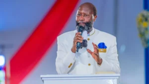 Pregador queniano David Owuor fala ao microfone durante evento religioso